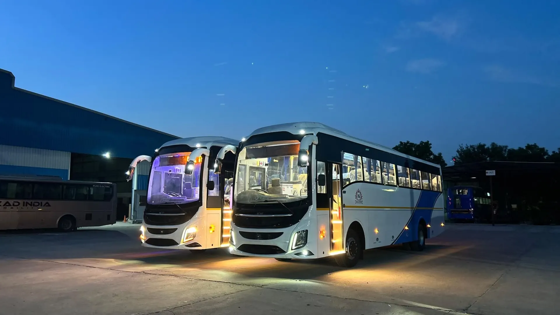 H K Tours and Travels AC coaches ready for the road at night